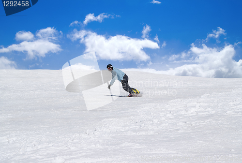Image of Snowboarder against blue sky