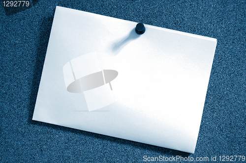 Image of blank sheet of paper on bulletin board