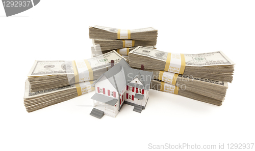 Image of Small House with Stacks of Hundred Dollar Bills