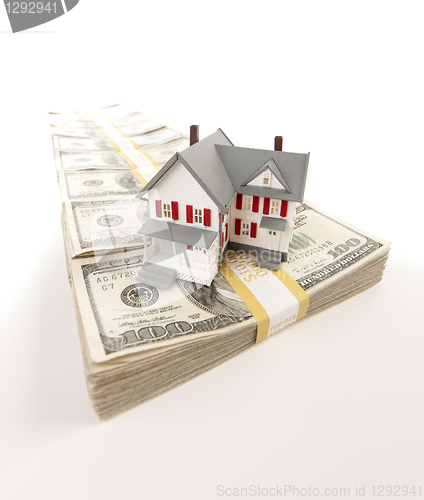 Image of Small House on Row of Hundred Dollar Bill Stacks