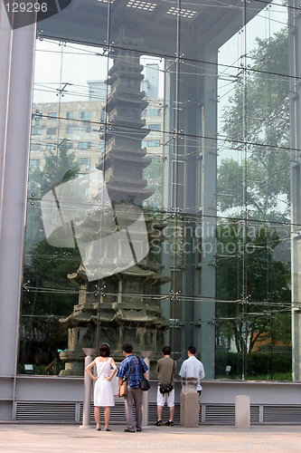 Image of Tourists look at a Buddhist structure - travel and tourism