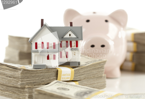 Image of Small House and Piggy Bank with Stacks Money