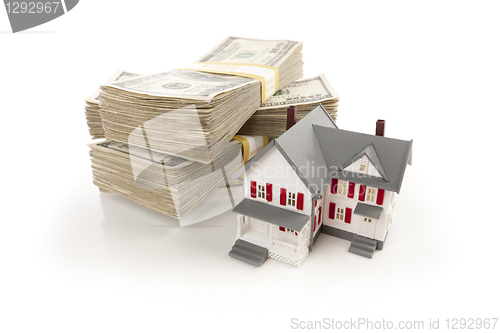 Image of Small House with Stacks of Hundred Dollar Bills