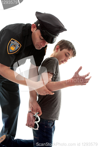Image of Policeman arresting teen criminal