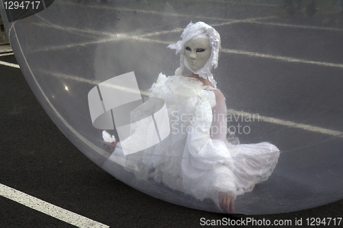 Image of Masked woman in a sphere