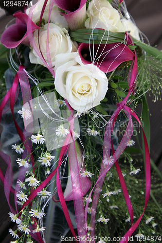 Image of White roses and purple Callas decorated with beautiful grinding