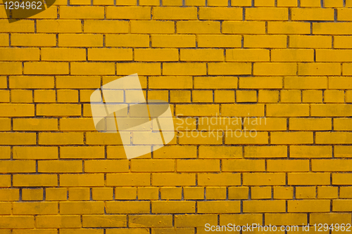 Image of Background with old yellow painted brick wall