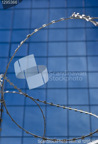 Image of Barbed wire on a background of office building