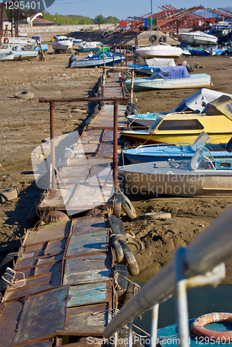 Image of boat marina and a boat moored near the shore