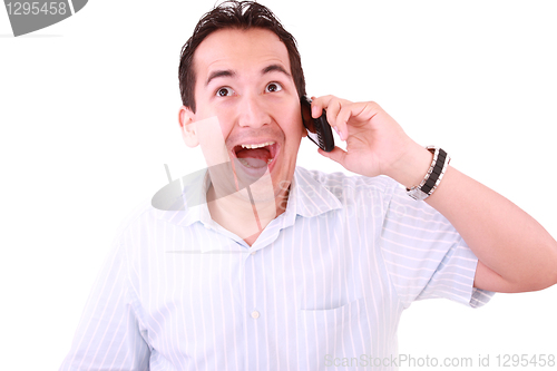 Image of Beautiful young man laughs and talks by mobile phone. 