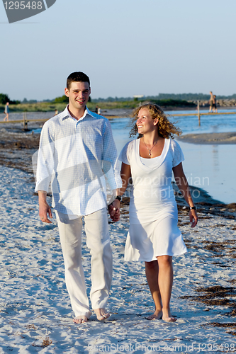 Image of Young couple walking on beach