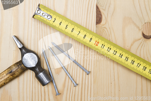 Image of Old hammer , tape measure and nails 