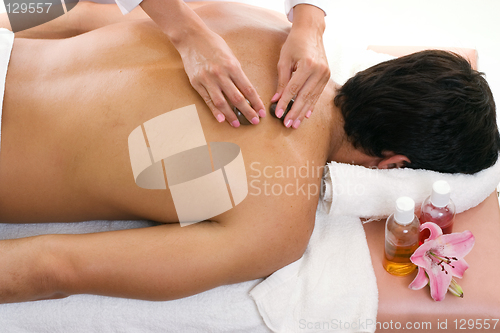 Image of Man receiving thermal stone massage