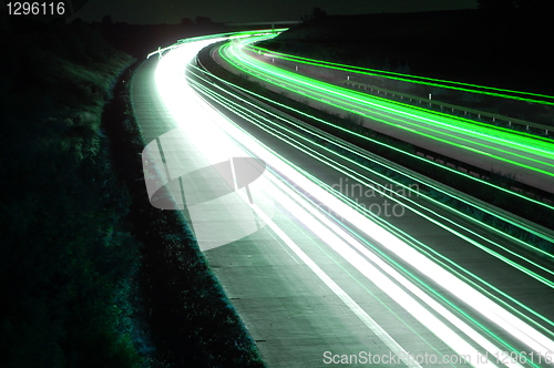 Image of road with car traffic at night with blurry lights