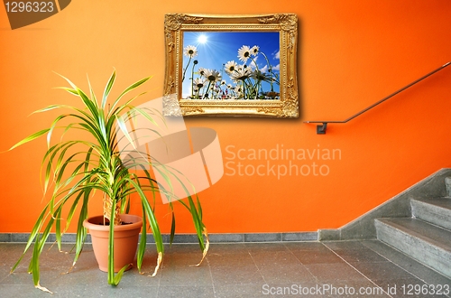 Image of picture on a wall and plant