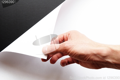 Image of hand turning paper