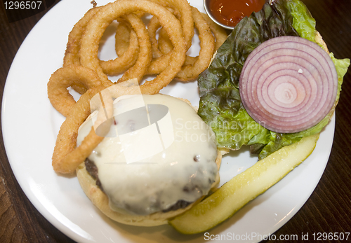 Image of cheeseburger onion rings pickle onions lettuce