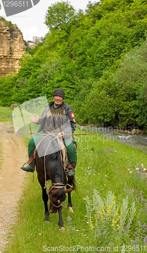 Image of An elderly mountain dweller on horseback