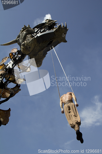 Image of Dragon and acrobat in the street.