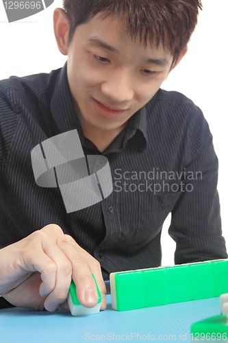 Image of Chinese man play Mahjong, traditional China gamble. 