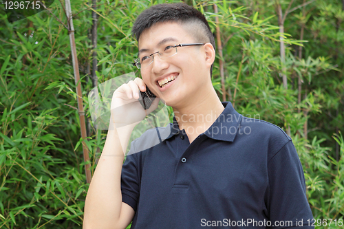 Image of asia man talking on phone