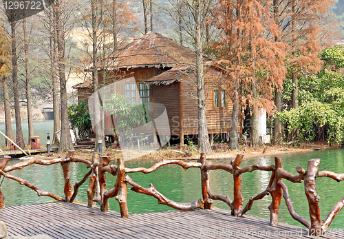 Image of wood house on water