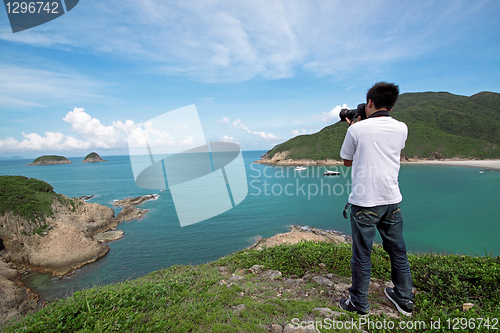 Image of photographer takes a photo of the landscape 