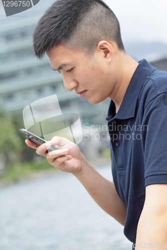 Image of man checking his phone outdoor