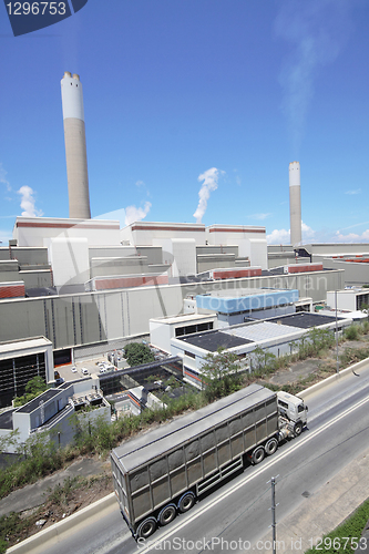 Image of coal fired power station and car moving