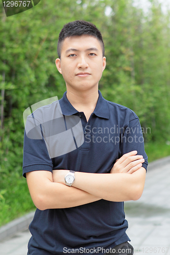 Image of young business man stand and hand cross