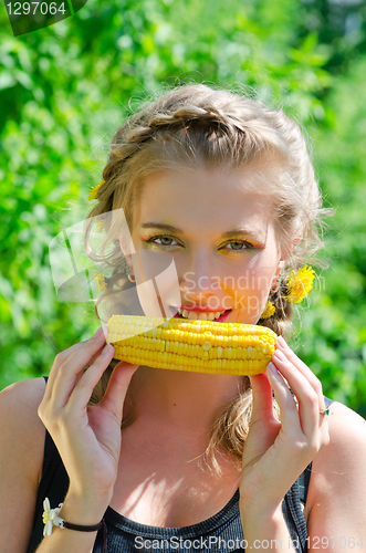 Image of woman eating corn-cob