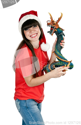 Image of Girl in Santa hat with a decorative wooden dragon