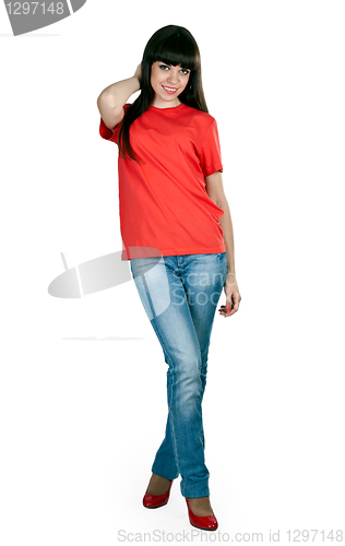 Image of girl in red shoes and blue jeans in the studio