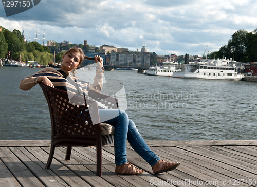 Image of girl sitting in the pier
