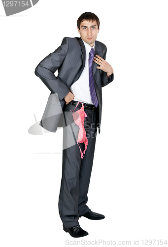 Image of businessman in a gray suit from his pocket a pink bra hanging