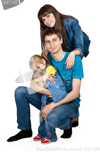 Image of father, mother and young daughter in jeans