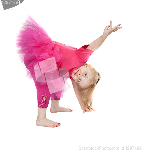 Image of little girl in a pink dress dancing in the studio bow