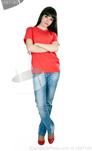 Image of girl in red shoes and blue jeans in the studio