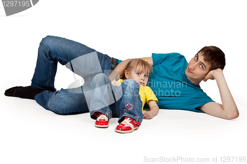 Image of dad and little daughter lying on the floor
