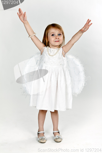 Image of little girl with angel wings in the studio