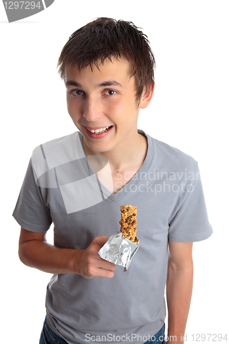 Image of Smiling boy holding muesli bar