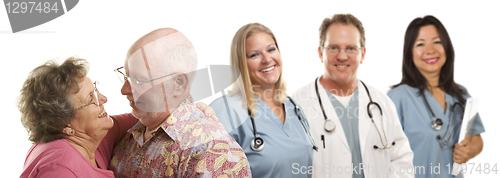 Image of Senior Couple with Medical Doctors or Nurses Behind