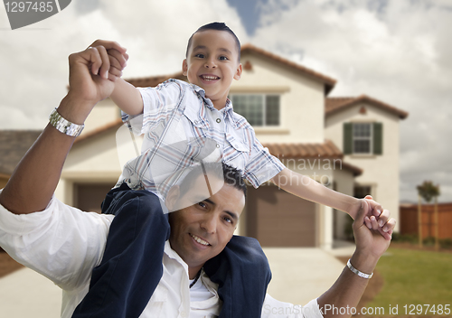 Image of Hispanic Father and Son in Front of House