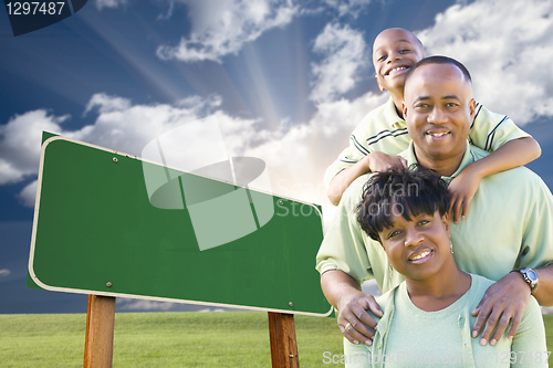 Image of African American Family in Front of Blank Green Road Sign