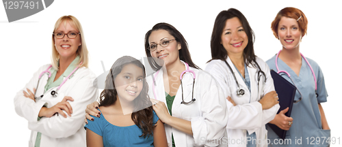 Image of Hispanic Female Doctor with Child Patient and Colleagues Behind