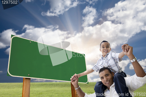 Image of Father and Son in Front of Blank Green Road Sign