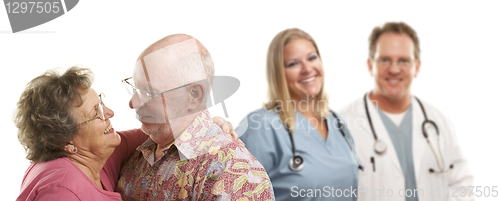 Image of Senior Couple with Medical Doctors or Nurses Behind