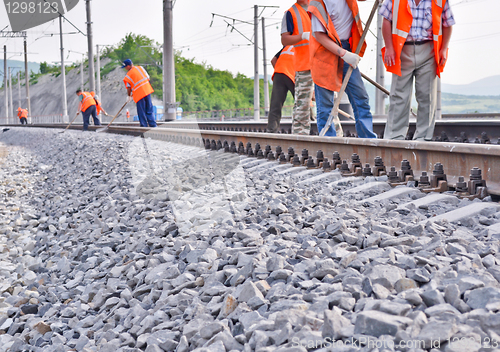 Image of railway embankment, rails and workers