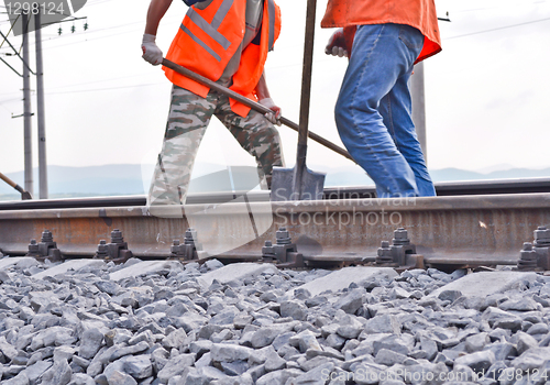 Image of railway embankment, rails and workers