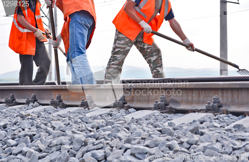 Image of railway embankment, rails and workers